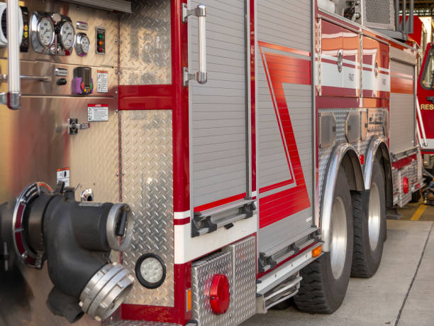 Side view of fire engine Side view of fire engine with gauges and hose connections side-view-of-a-fire-truck stock pictures, royalty-free photos & images