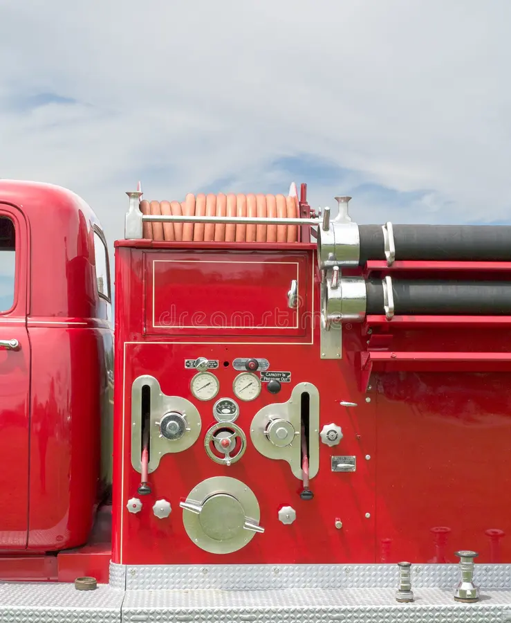 A side view of an old firetruck with it's pump controls and hoses. Fire truck side view stock images, royalty-free photos and pictures