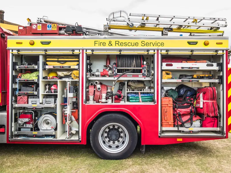 The side view of equipment packed neatly inside a fire engine, fire truck. Fire engine side stock images, royalty-free photos and pictures