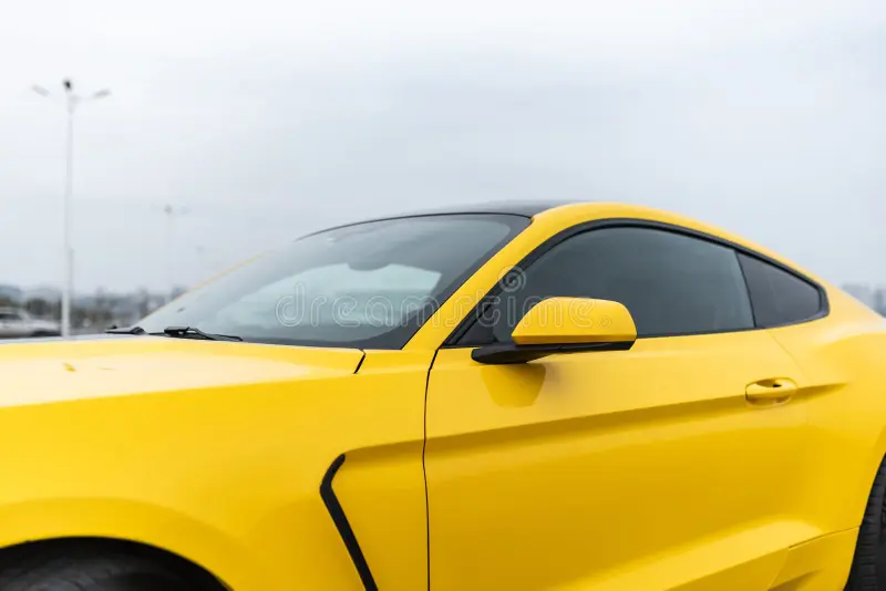 Yellow with black stripes Ford Mustang muscle car in a parking lot. Side view. Russia, Rostov-on-Don 23 Oct2021. Ford mustang side view stock images, royalty-free photos and pictures