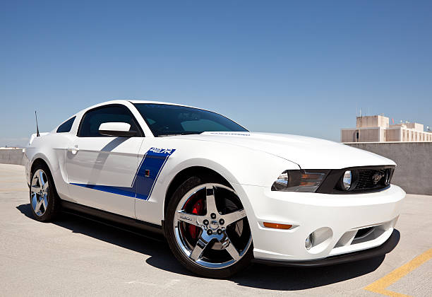 Roush Ford Mustang 2010 Scottsdale, United States - September 28, 2011: A photo of a parked white 2010 Ford Mustang, this Mustang happens to be the Roush edition and features more aggressive body style and a supercharged engine. mustang car side view stock pictures, royalty-free photos & images