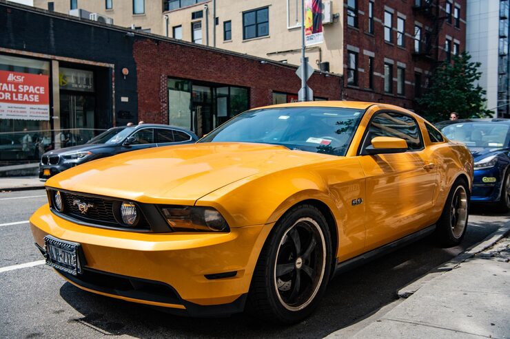 Photo new york city usa august 05 2023 2011 ford mustang v6 yellow car front and driver side view parked
