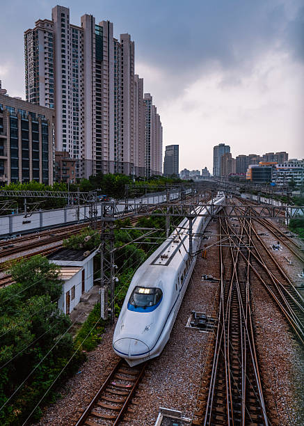 china high speed train (bullet trains) approaching shanghai city,moving through the residential district - fuxing train stock pictures, royalty-free photos & images