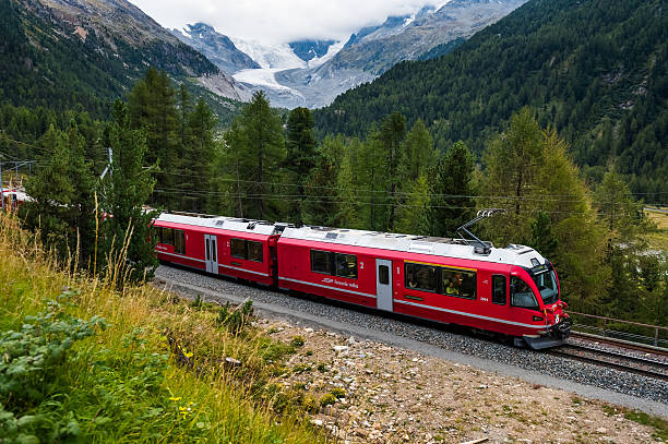overlooking view of train running on the bernina railway in switzerland. - glacier-express-switzerland stock pictures, royalty-free photos & images