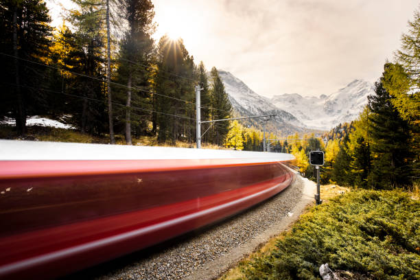 Rhaetian Railway in front of Bernina Narrow gage train approaching Morterasch station with the Bernina mountain in the background glacier-express-switzerland stock pictures, royalty-free photos & images