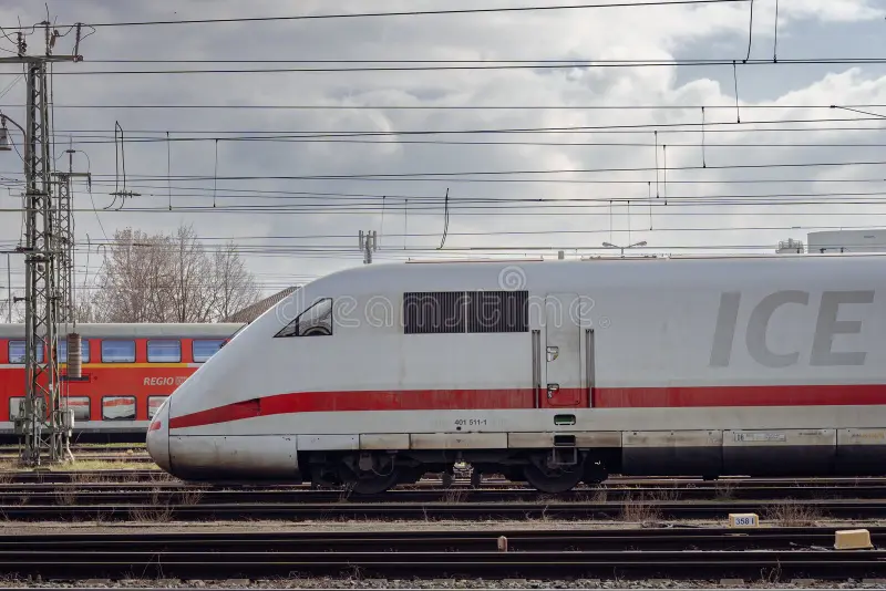 Side view of a Intercity-Express locomotive on the railroad with the regional train in the background. Ice train side view stock images, royalty-free photos and pictures