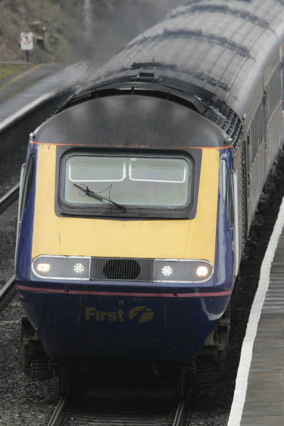 'First Great Western' InterCity 125 train on the line to the west of England passes though Iver station to Paddington.