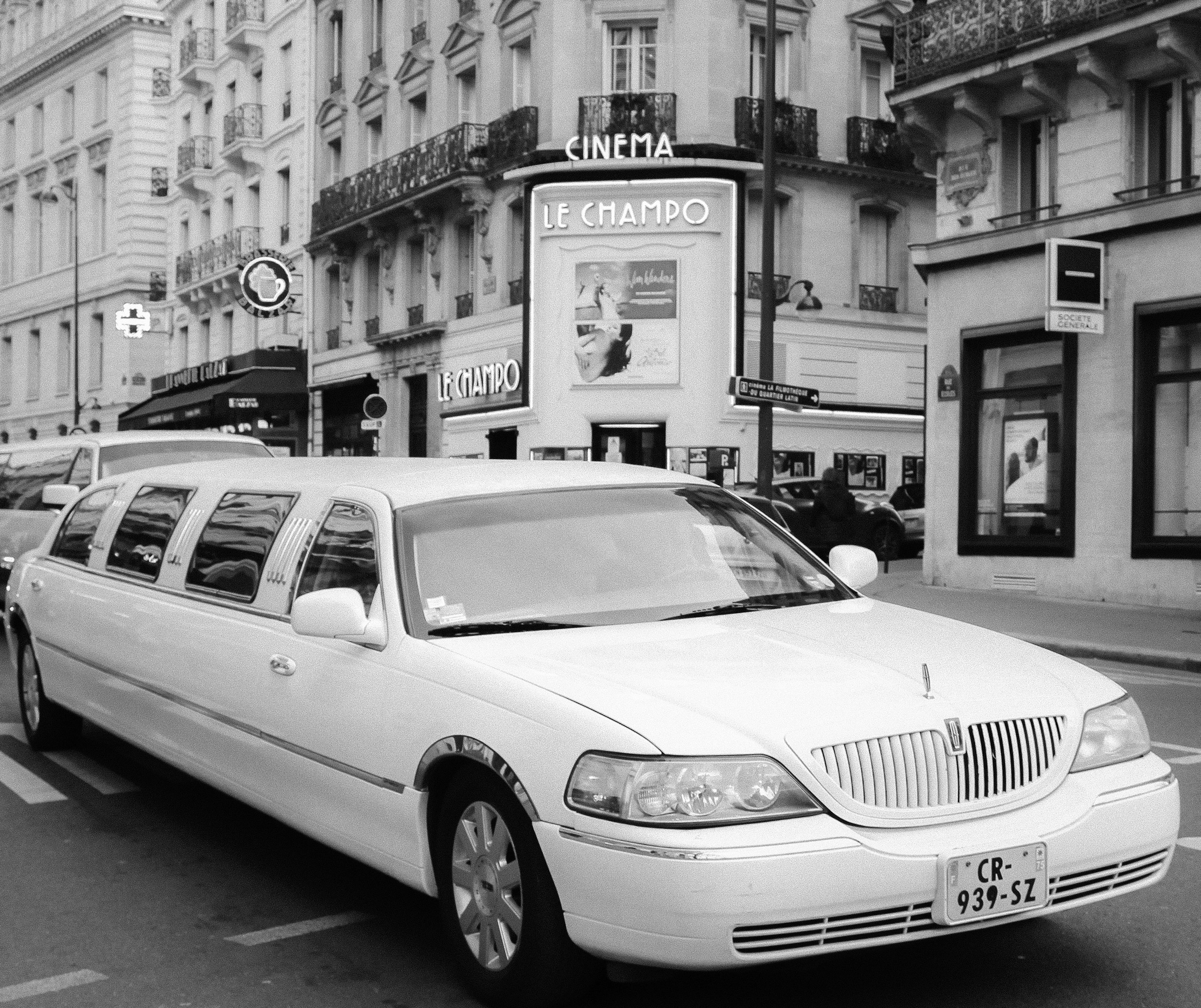 a white limousine parked on the side of the road
