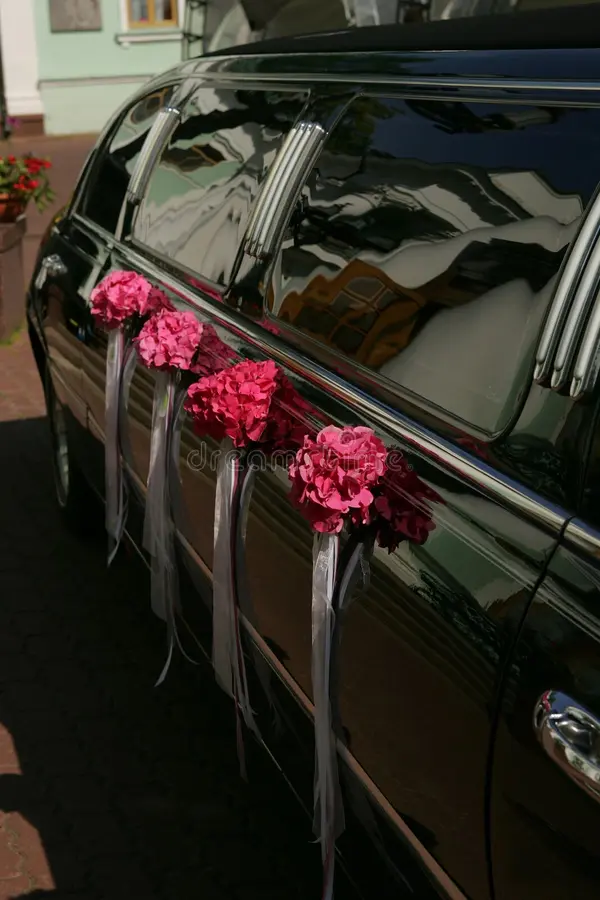 Close up portrait of the side of a black wedding car limousine pictured parked on the road. Stretch limousine stock images, royalty-free photos and pictures