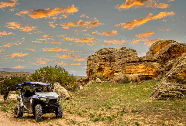 4x4 Side-by-Side off-road vehicle, UTV ATV with a beautiful mountain range in the background near the Colorado and Utah border. 4x4 Side-by-Side off-road vehicle, UTV ATV with a beautiful mountain range in the background near the Colorado and Utah border. side by side atv stock pictures, royalty-free photos & images