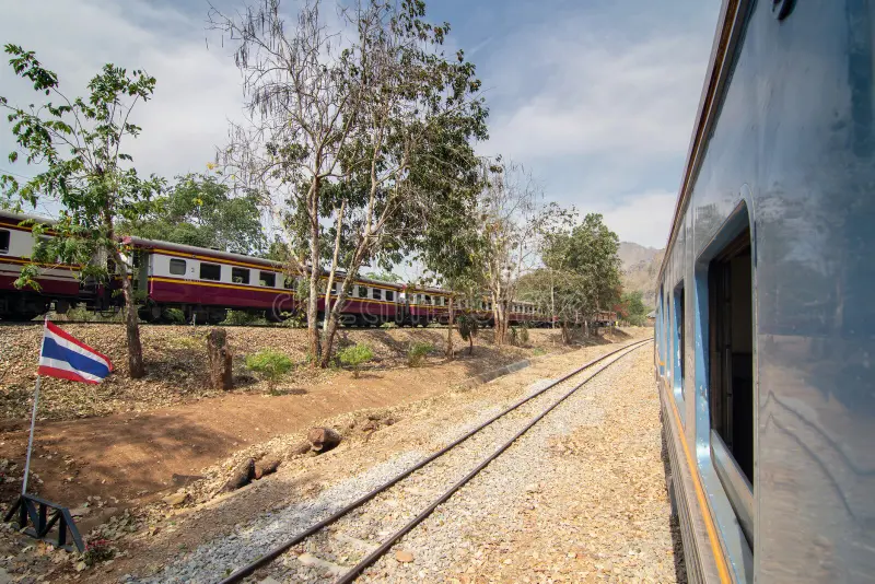 Side view of old passenger train moving through railway station at summer. Passenger train side view stock images, royalty-free photos and pictures