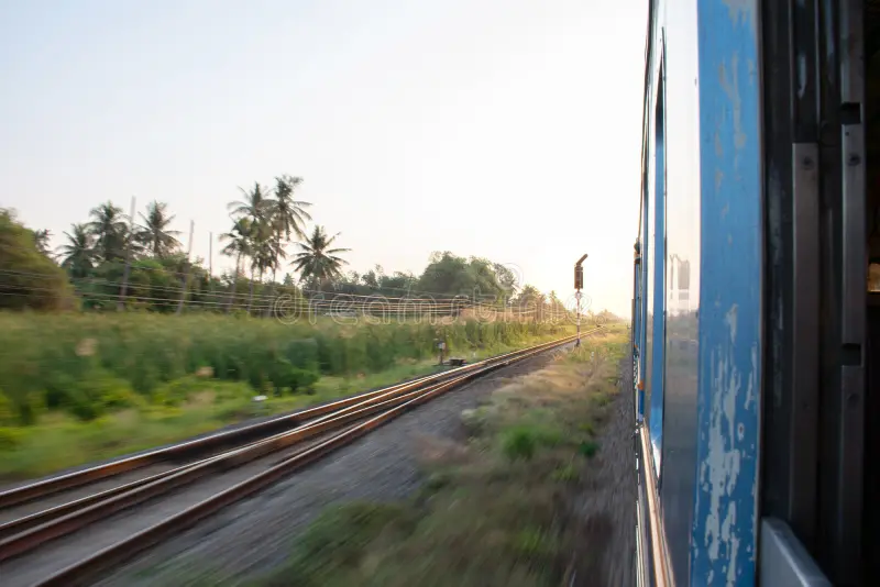 Side view of old passenger train moving through natural landscape at sunset. Passenger train side view stock images, royalty-free photos and pictures