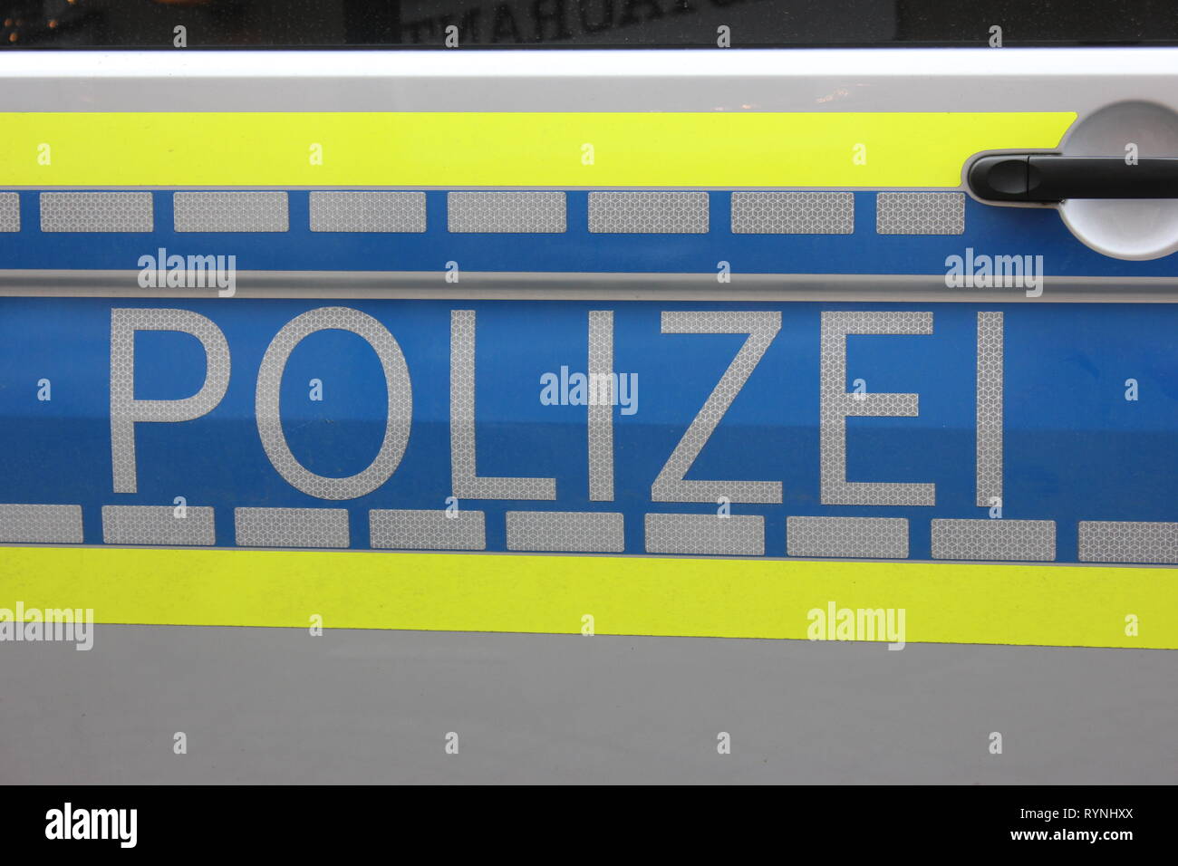 Side view german police car on door, labeled with reflecting letters. - Stock Image