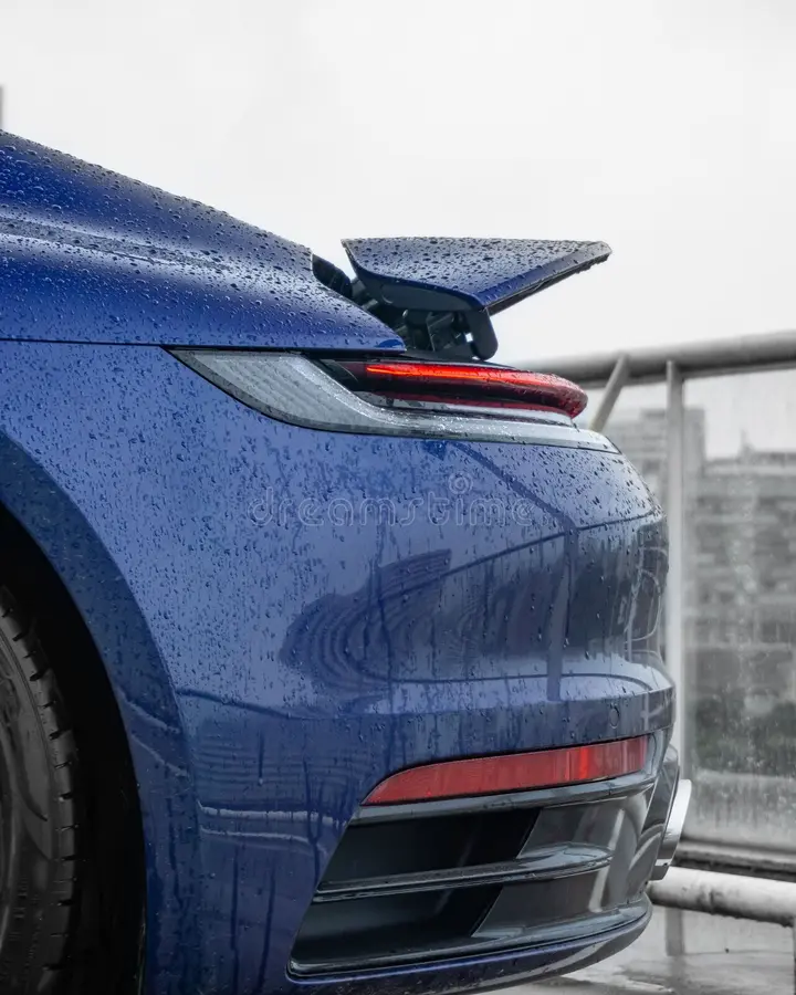 A vertical shot of a blue Porsche 911 Carrera S rear side view. Porsche 911 side view stock images, royalty-free photos and pictures