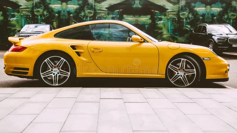 Moscow , Russia - May 2021: luxury sportscar Porsche 997 Turbo yellow color parked next to Moscow City business center. Porsche 911 side view. Porsche 911 side view stock images, royalty-free photos and pictures