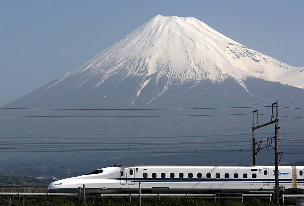 Central Japan Railway Co.'s N700 series Shinkansen bullet train travels past Mount Fuji, in Fuji City, Shizuoka Prefecture, Japan, on Friday, April...