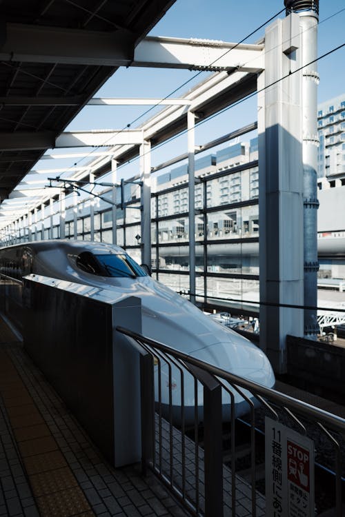 Free Bullet train at modern railway station, showcasing sleek design and urban architecture. Stock Photo