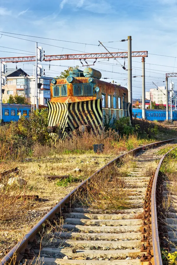 Rusty snowplow locomotive on railroad during summeer. Railroad snowplow stock images, royalty-free photos and pictures