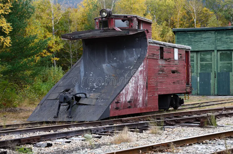 Vintage wooden railroad snowplow located in New Hampshire rail yards. Railroad snowplow stock images, royalty-free photos and pictures