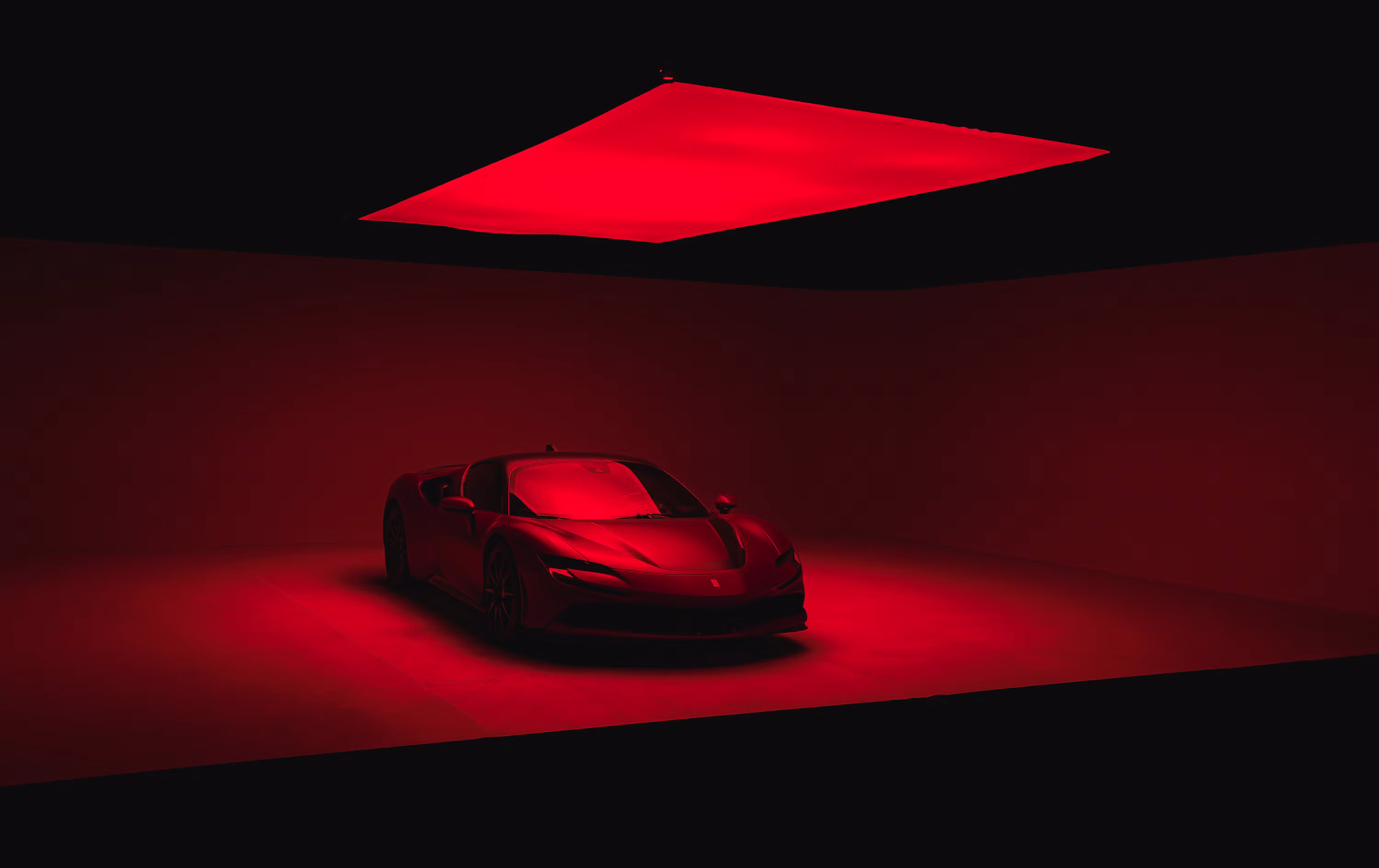 a red sports car in a dimly lit room