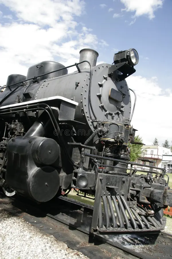 Side view of old steam train engine on railway track. Steam train side view stock images, royalty-free photos and pictures