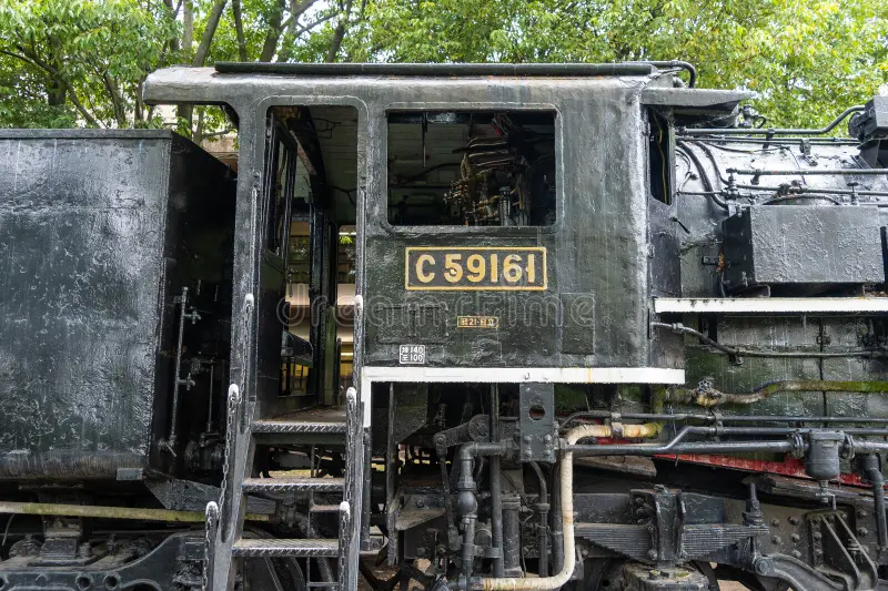 Close-up side view of the historic C59 161 steam locomotive, preserved as a mechanical monument in a peaceful park in Hiroshima, Japan. Steam train side view stock images, royalty-free photos and pictures