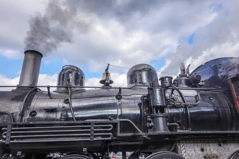 Side view of an old steam locomotive engine with smoke coming from the stack. Steam train side view stock images, royalty-free photos and pictures