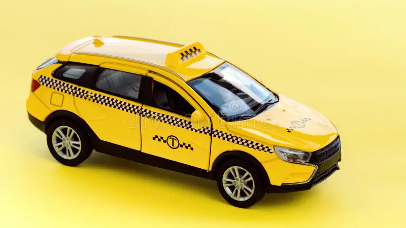 Yellow taxi cab on a yellow background macro photography. Taxi car side view. Service for getting around the city by taxi. Taxi service use concept. Taxi cab side view stock images, royalty-free photos and pictures