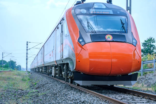 Vande Bharat Express Pune, India - September 22 2024: Saffron coloured Vande Bharat Express near Pune India. This is a tri-weekly train between Pune and Kolhapur and also a tri-weekly train between Pune and Hubballi. vande bharat express stock pictures, royalty-free photos & images
